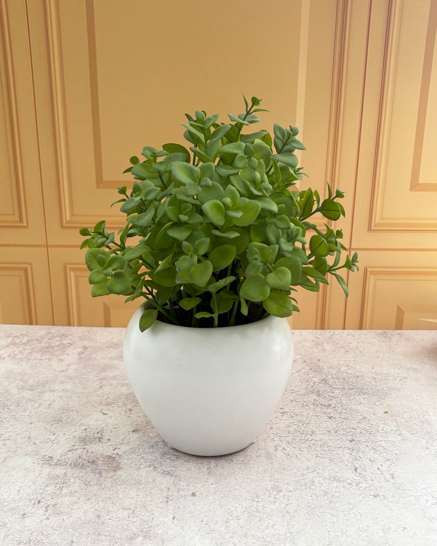 Maceta de cerámica con planta decorativa artificial